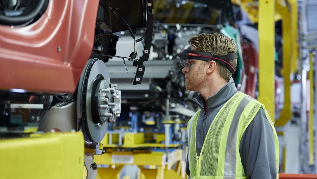 Male engineer checking vehicle at car plant