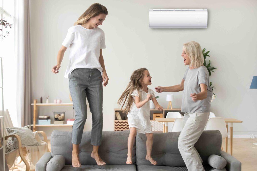 Happy kid, mother and grandmother having fun jumping on sofa